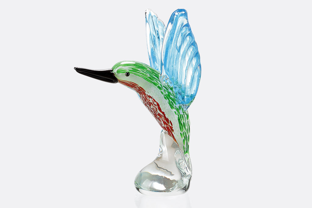Colorful glass hummingbird figurine on a white background