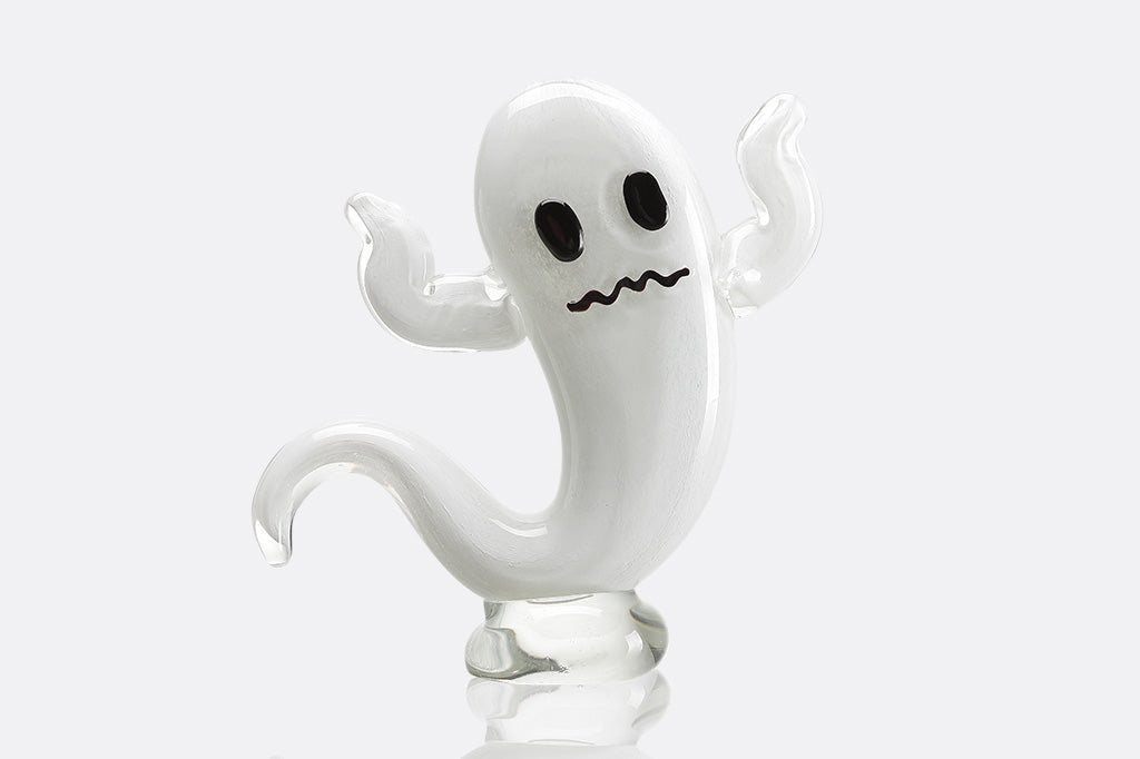 White ghost figurine with a spooky expression on a white background