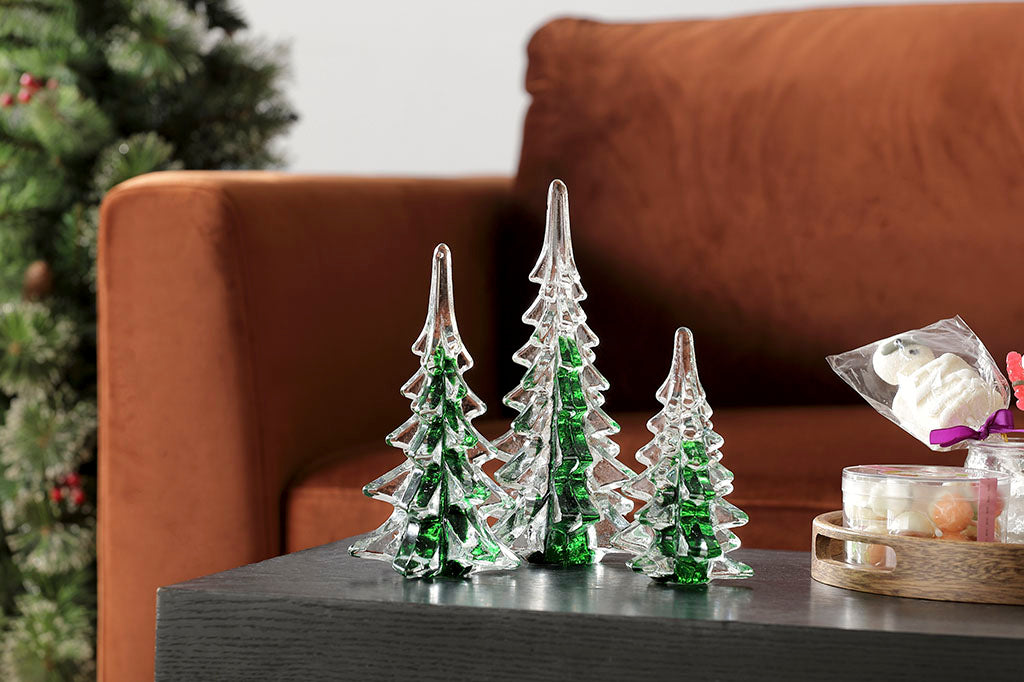 Set of 3 glass trees used as a holiday table ornament in a Christmas scene living room