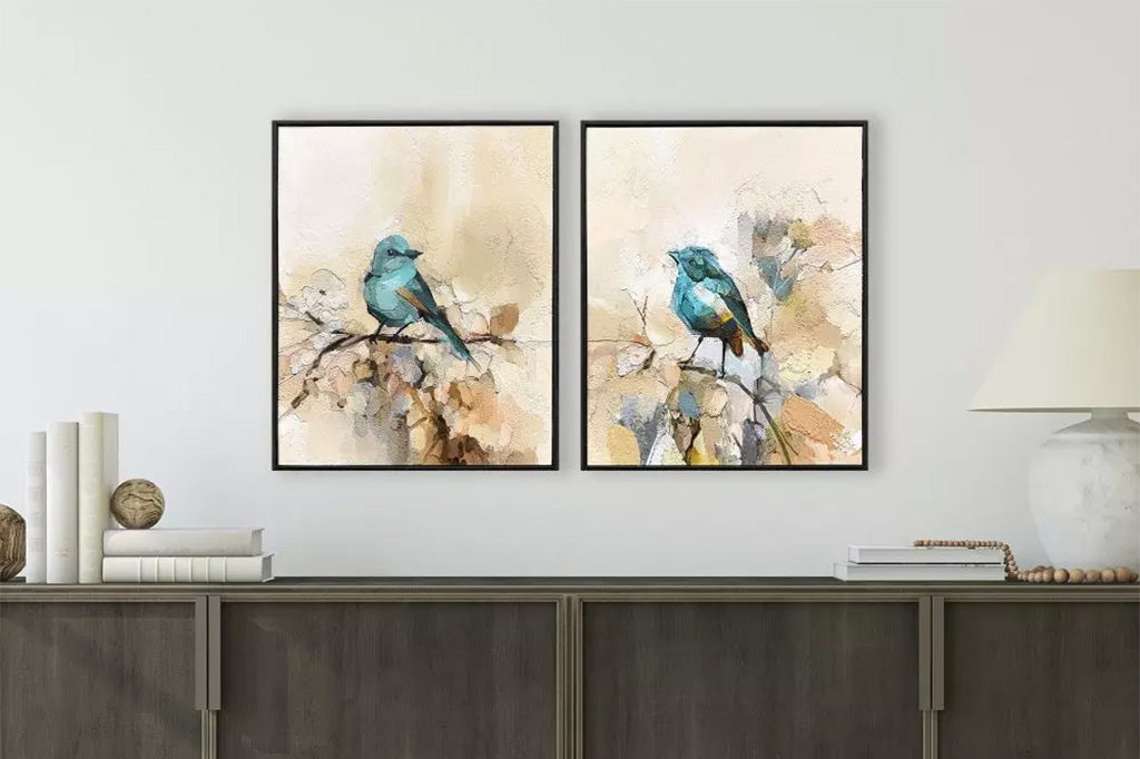 Two framed artworks of blue birds on a branch.