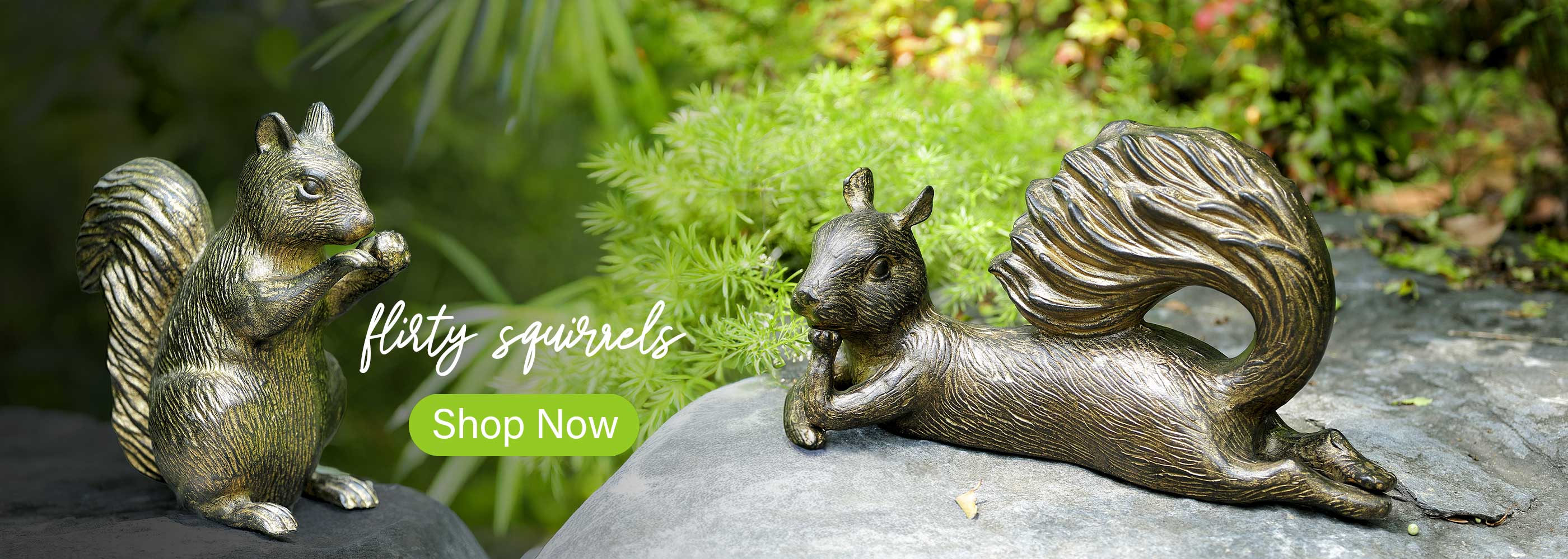 Two bronze squirrel sculptures on a rock with a blurred natural background