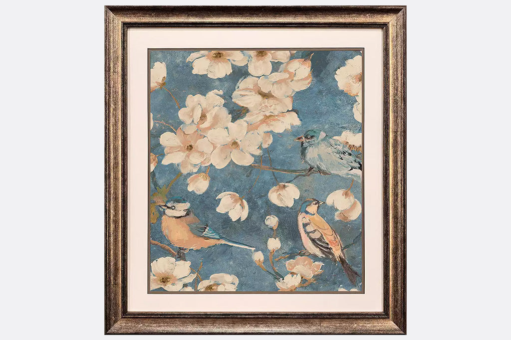 Framed artwork of three birds and flowers.