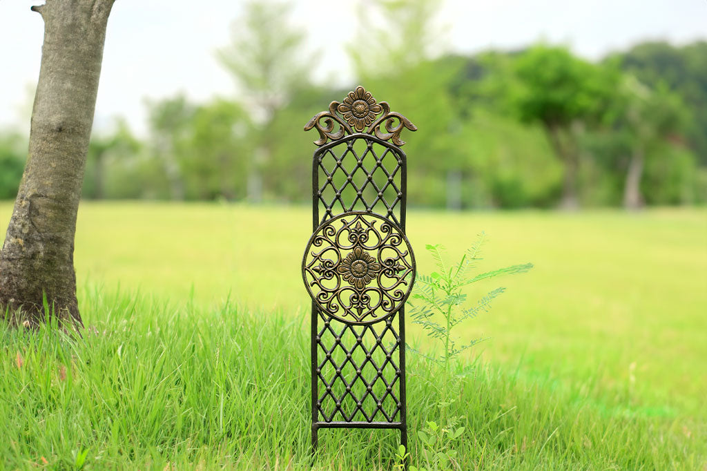 Girasole planter trellis shown in field next to a tree trunk.