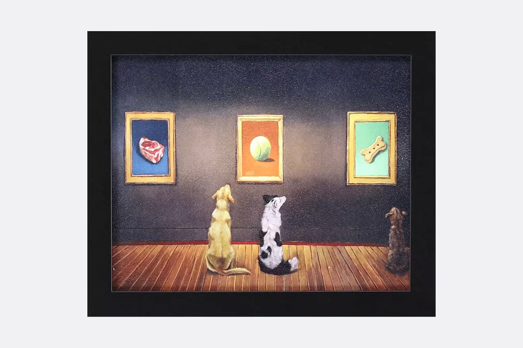 Framed artwork of three dogs looking at paintings on a wall of a steak, a ball, and a dog biscuit.