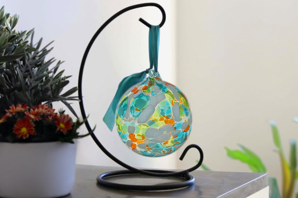 Handblown glass ornament designed to hang from metal stand