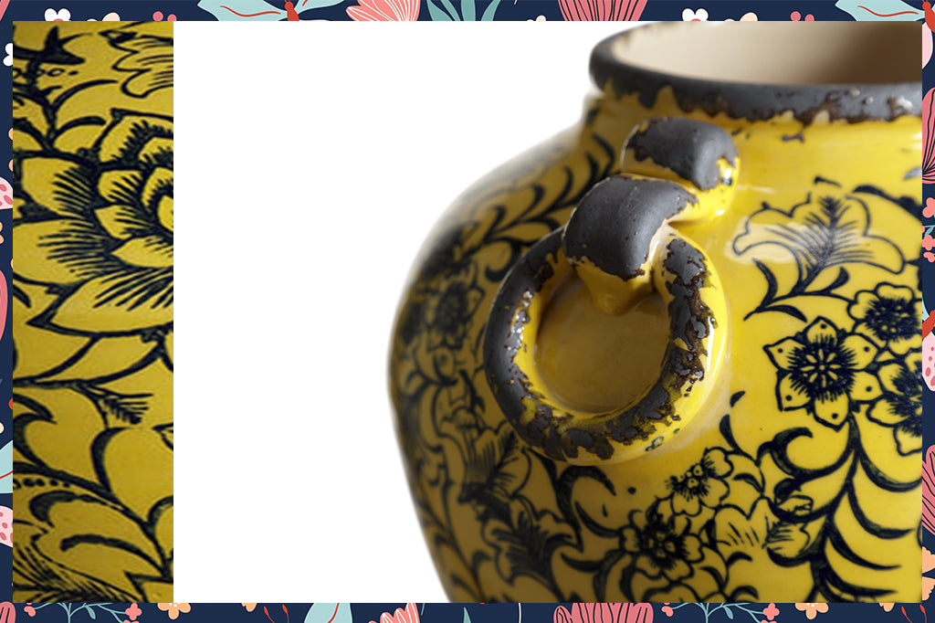 Detailed view of yellow and blue floral ceramic patterned pot 