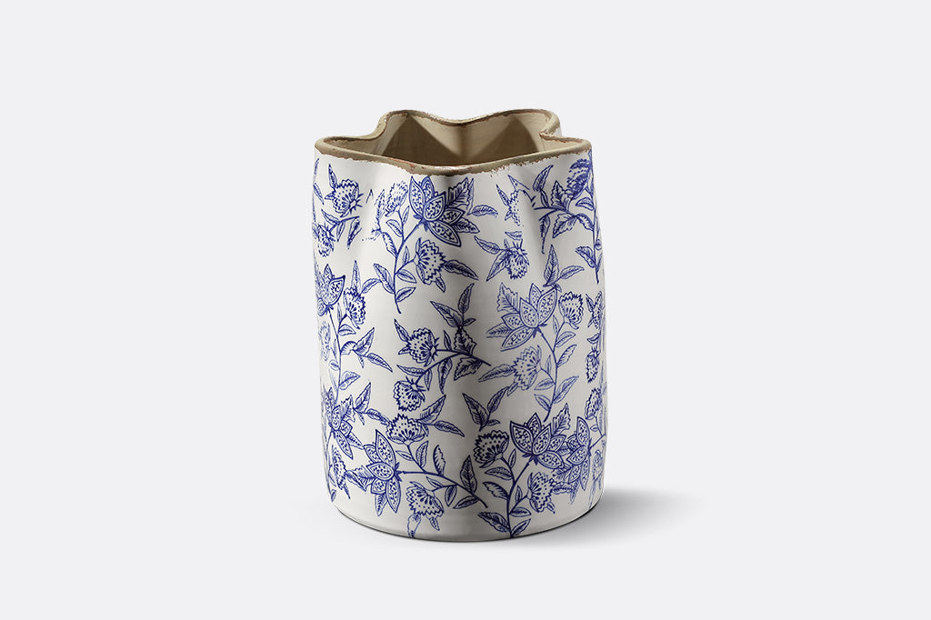 Ceramic vase with blue floral pattern on a white background