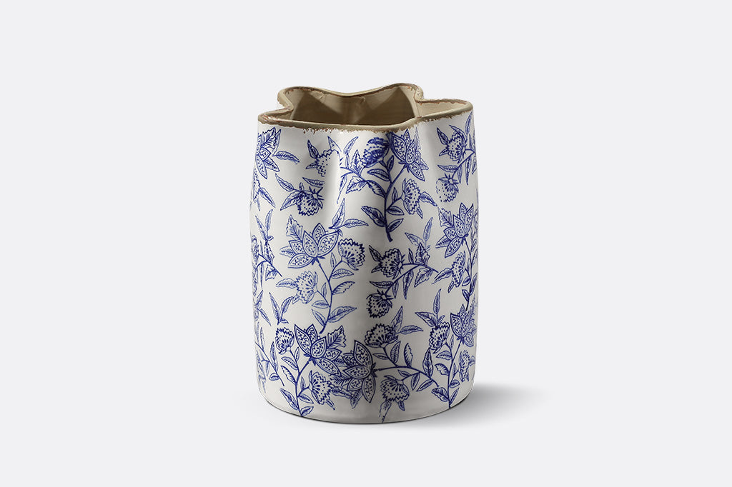 Ceramic vase with blue floral pattern on a white background