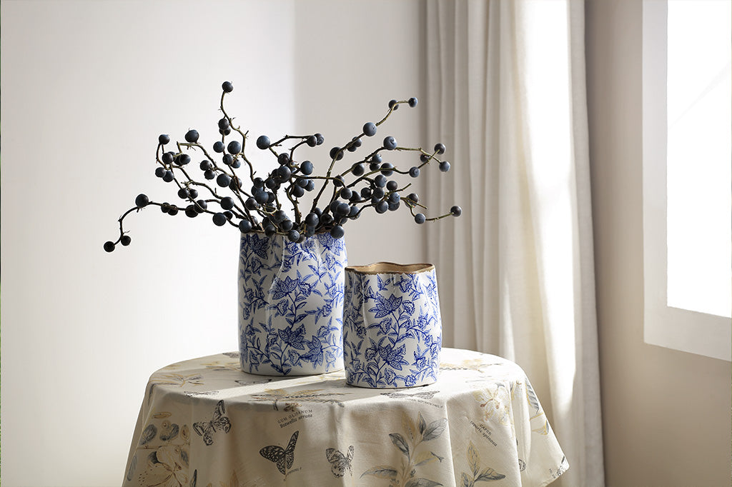 A white vase with blue floral patterns