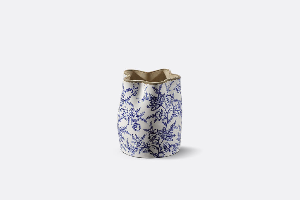A white vase with blue floral patterns