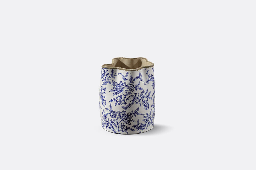A white vase with blue floral patterns