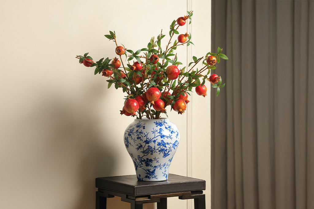 A white and blue Chinoiserie vase with bluebirds and branches