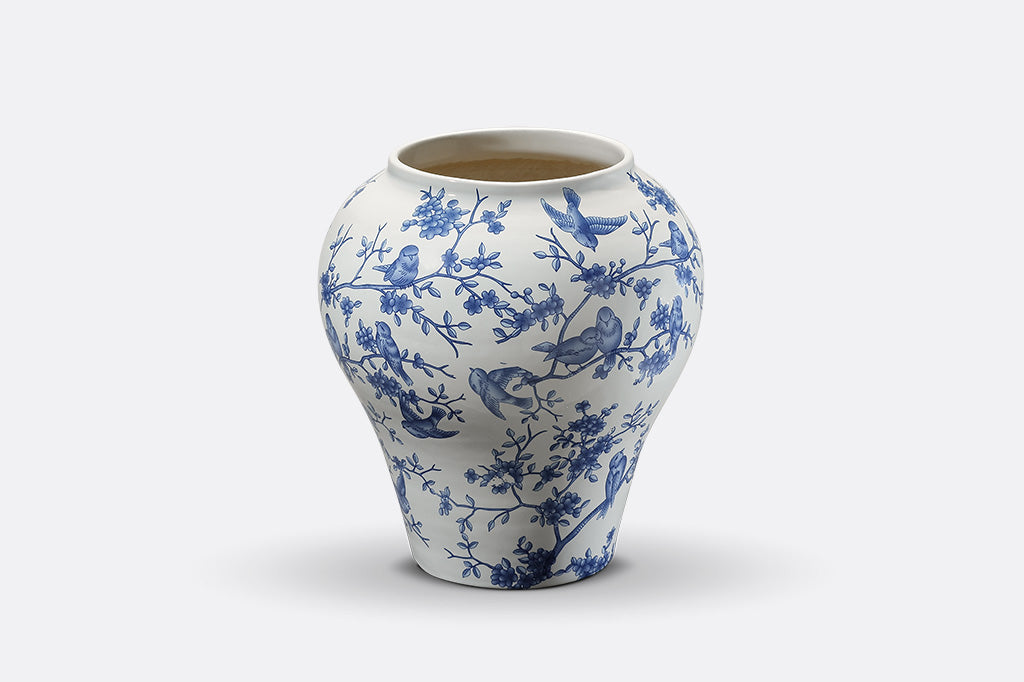 A white and blue Chinoiserie vase with bluebirds and branches
