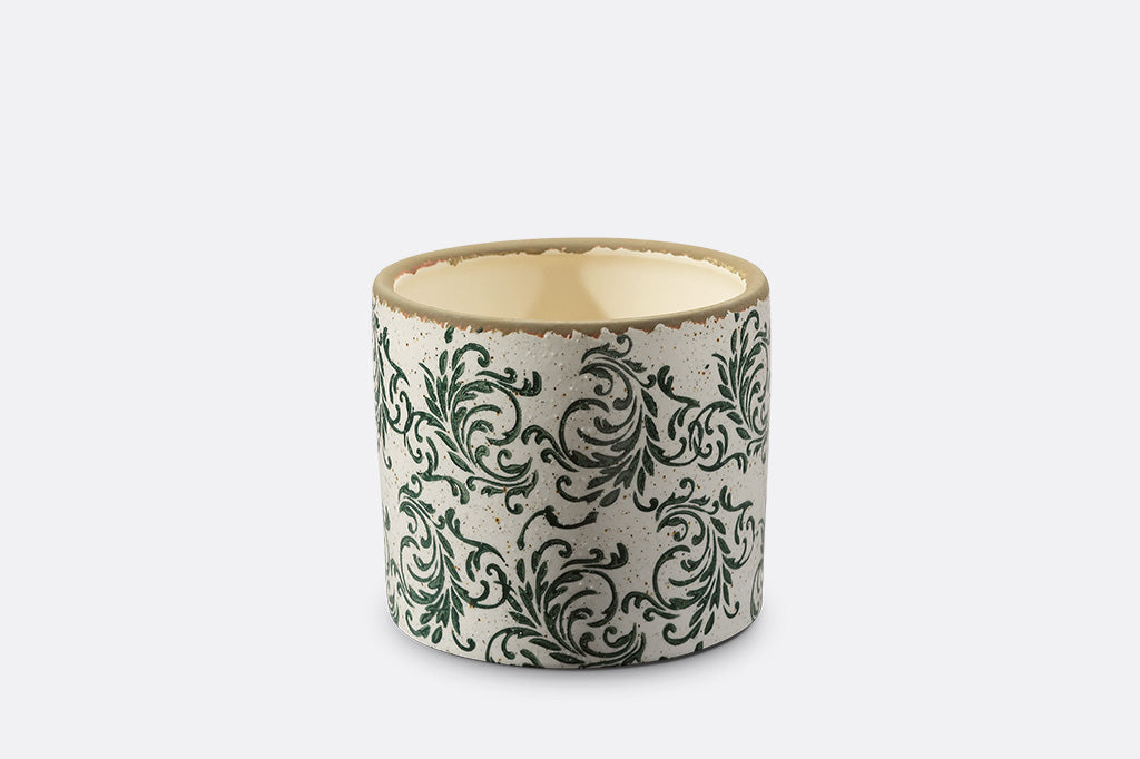 Ceramic pot with decorative green patterns on a white background