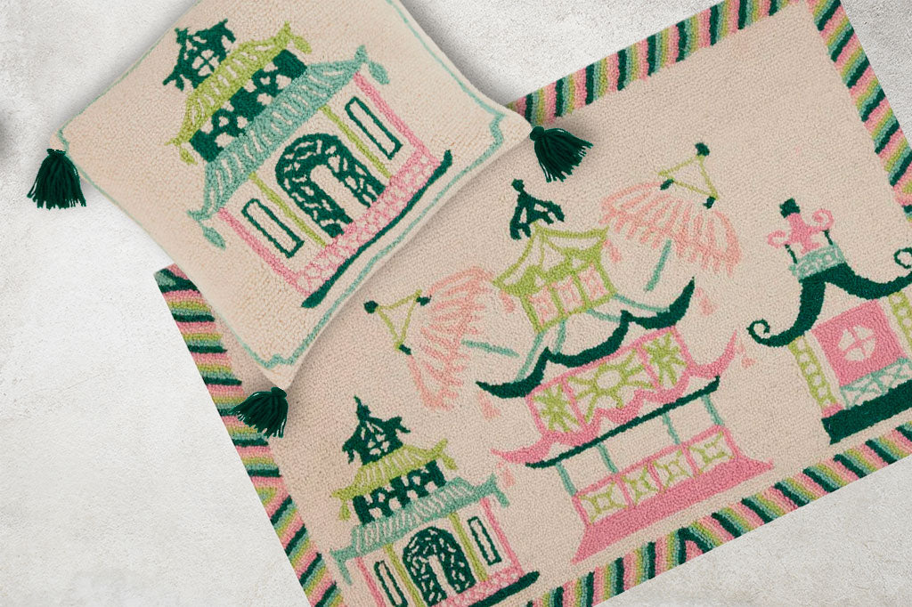 In cream and pastel, a modern take on asian pagoda of green, mint, and pink. Hooked wool pillow and doormat shown on concrete floor