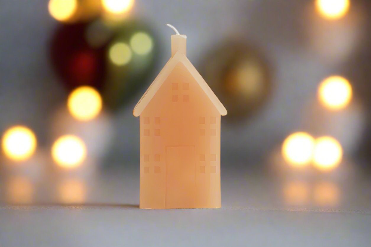 house shaped votive candle shown in holiday scene with Christmas lights