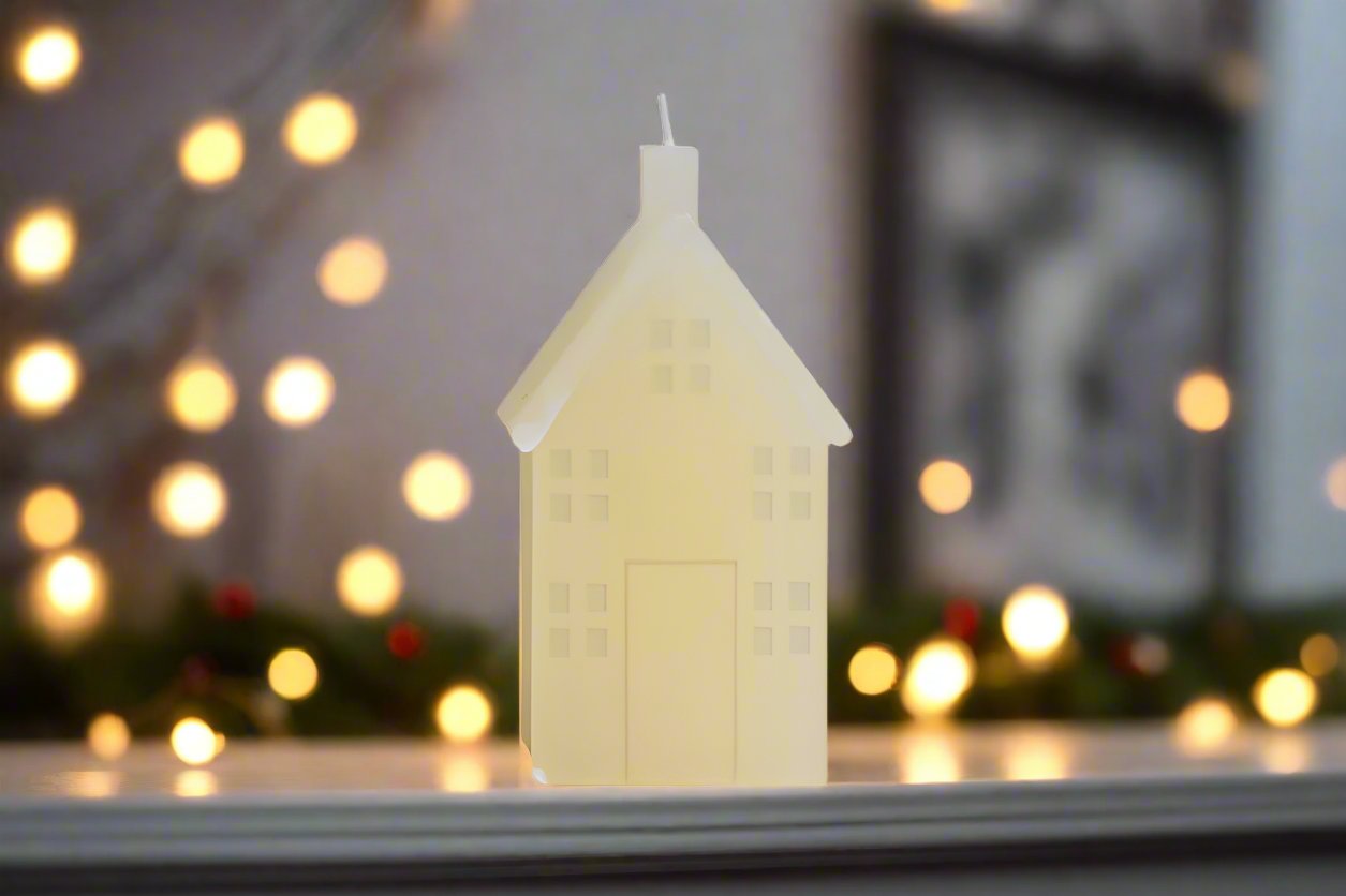 house shaped votive candle for Christmas scene decorating, lights in background