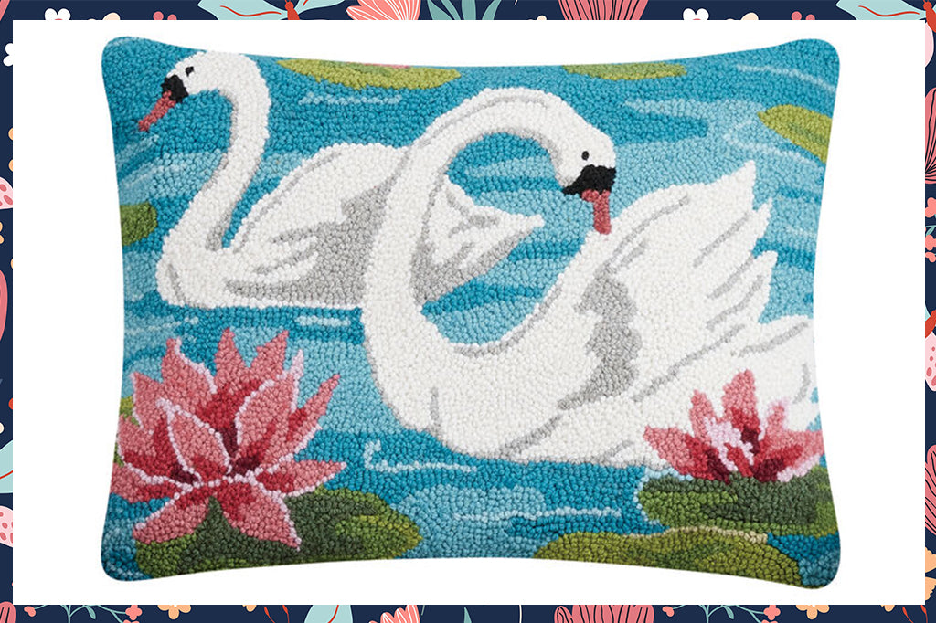 Hooked lumbar pillow displaying two swans and pink water lilies 
