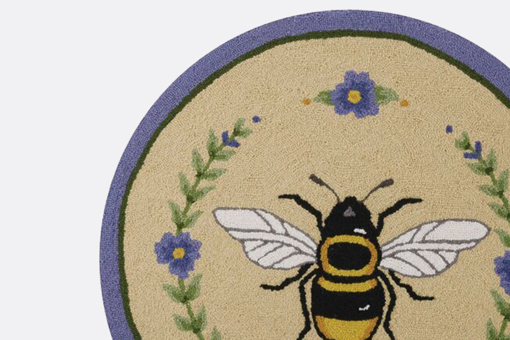 Detailed view of hooked rug texture and bee motif 