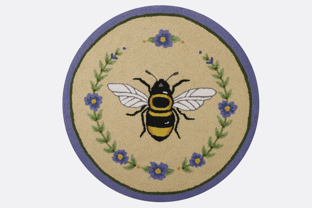 Round bee and purple flower rug with small purple flowers surrounding center bee