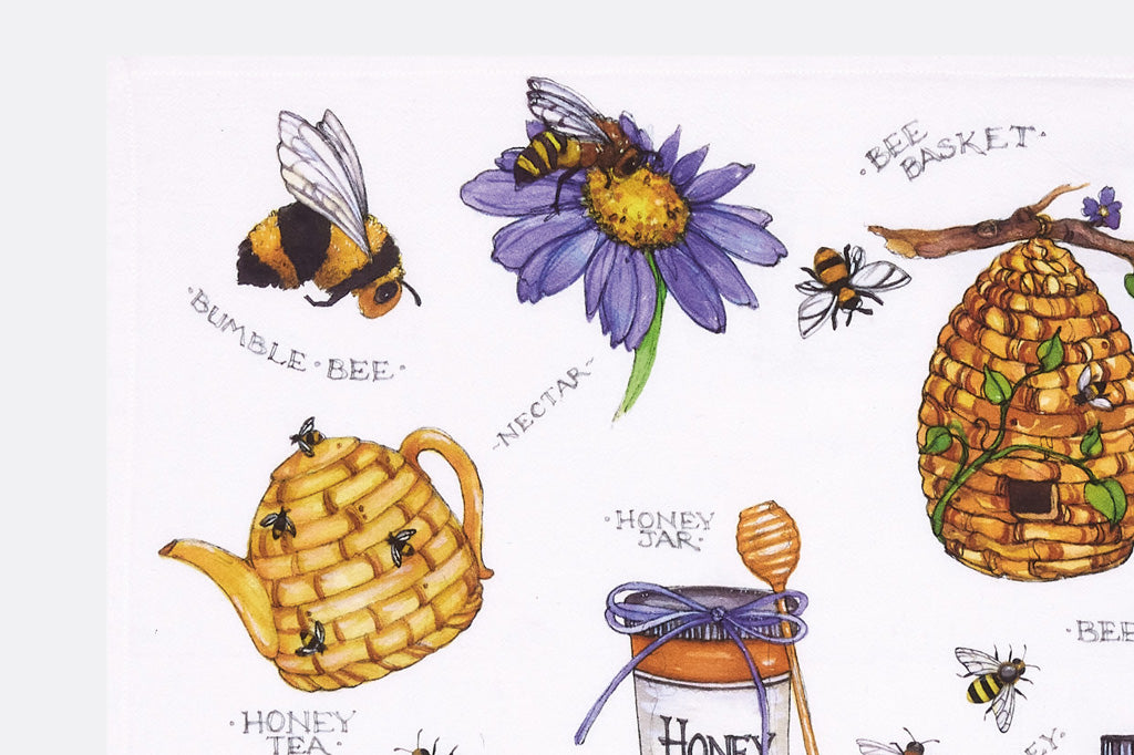 closeup view of print on  tea towels with honey and buzzing bees 