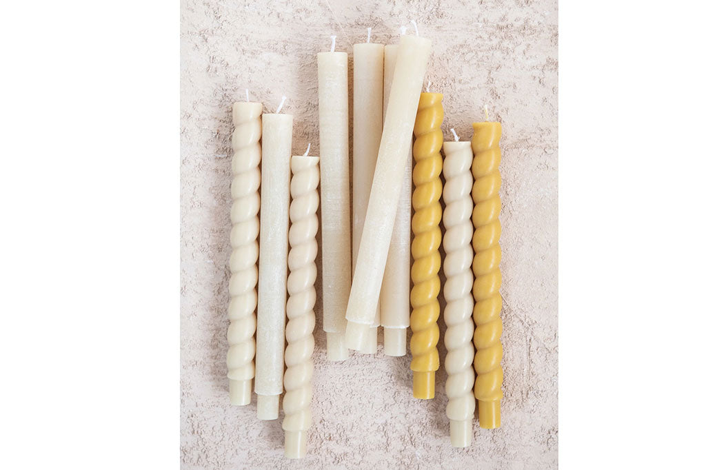 cream colored twisted taper candle, with yellow and white taper candles 