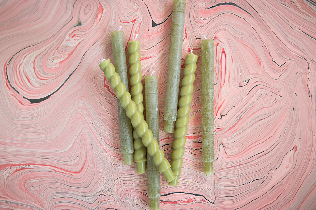 collection of twisted green and pillar green taper candles 