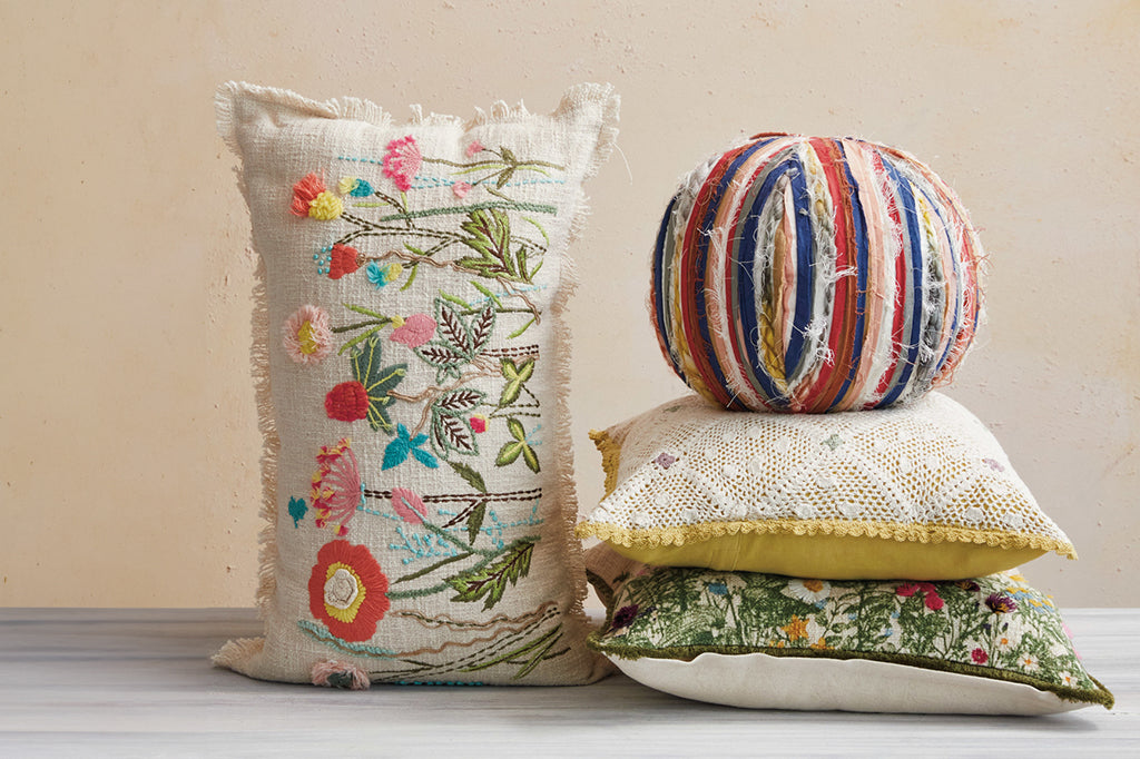 floral lumbar pillow staged with three other pillows 