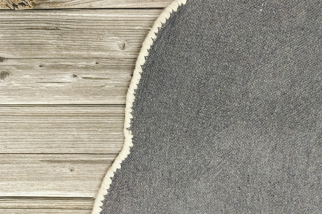 back side of circular rug with heather gray backing 