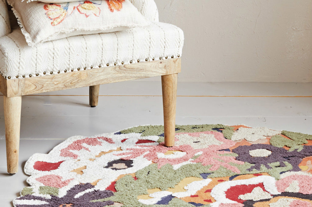 tuffed rug modeled in room with arm chair 