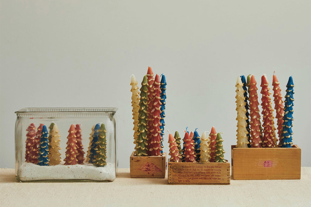 tree shaped taper candles in green color with gold trimming on edges shown with collection of many color versions