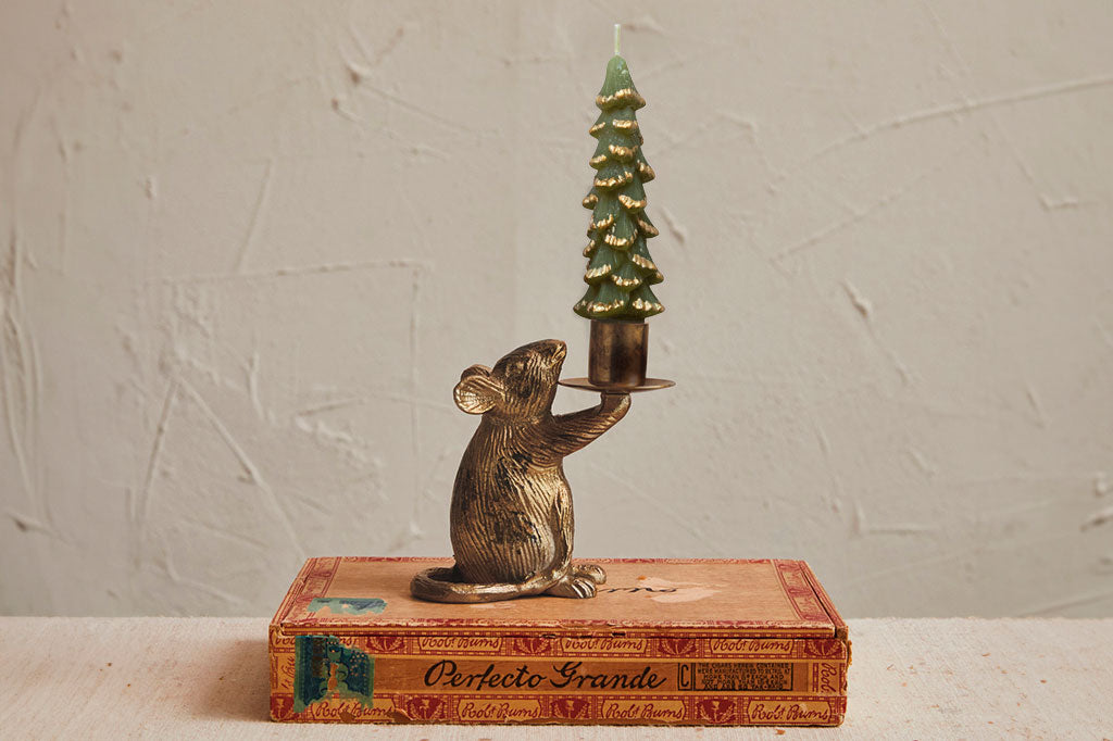 Taper Candleholder in tarnished bronze finish shaped like a mouse holds a holiday candle on vintage cigar box