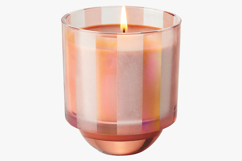 This pinky striped candle glass with dark peach wax shown lit