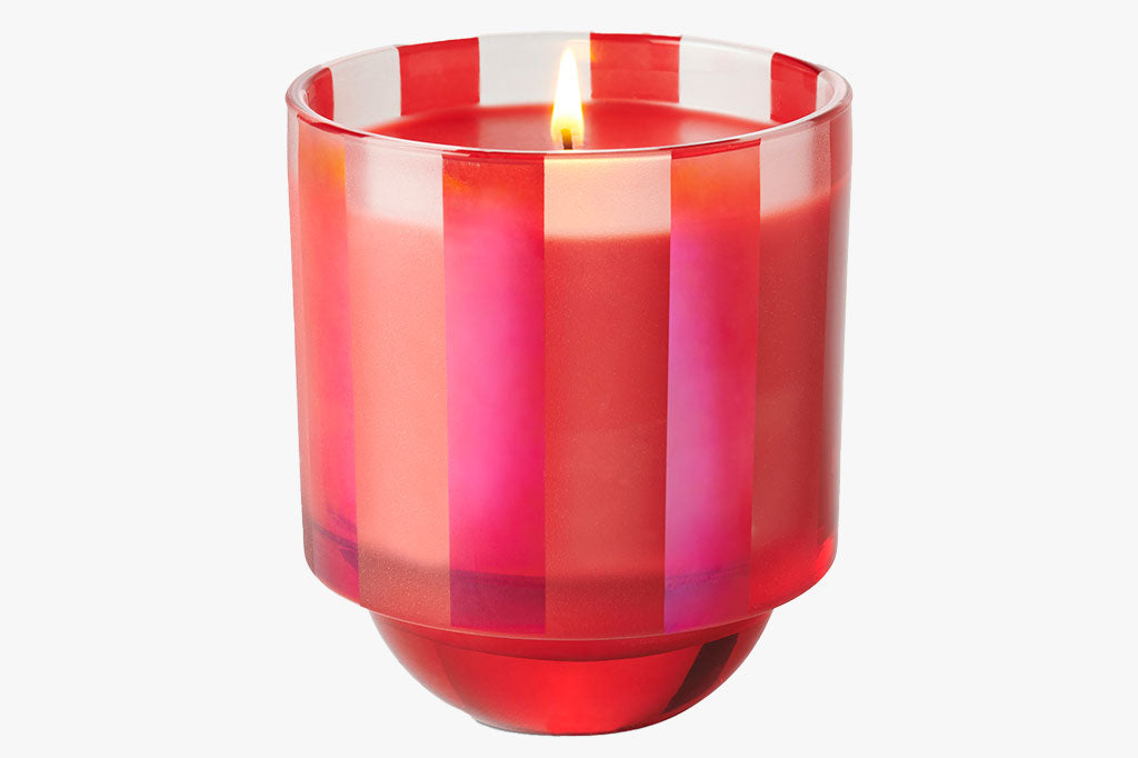 pinky-red striped candle glass with red wax. bowl-like base