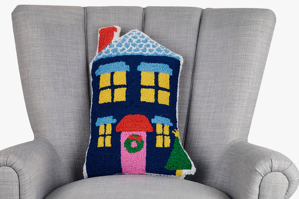 hooked wool pillow features a charming blue house shape with christmas wreath and tree on porch