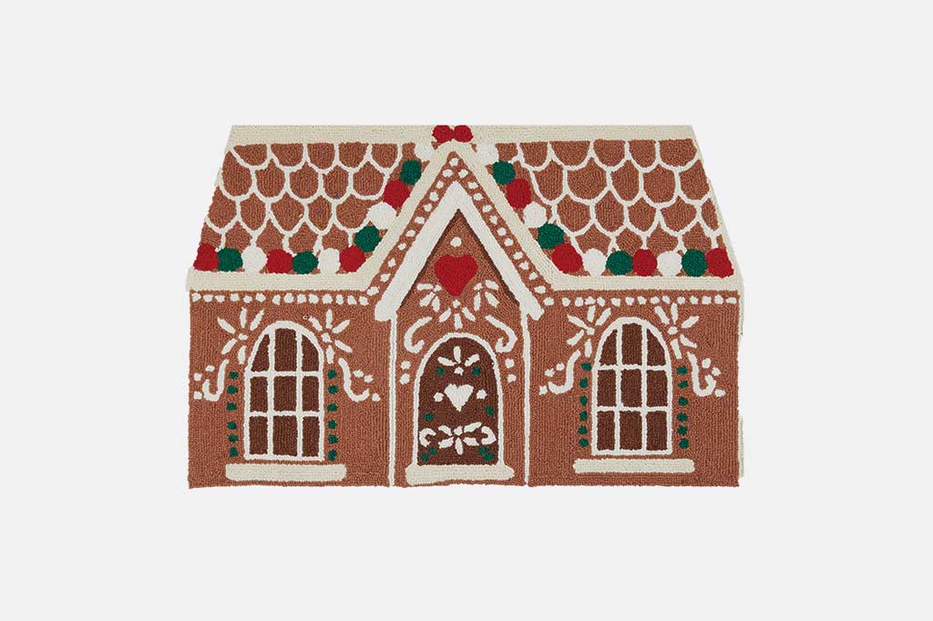 hooked wool rug shaped and designed to look like a decorated gingerbread candy house