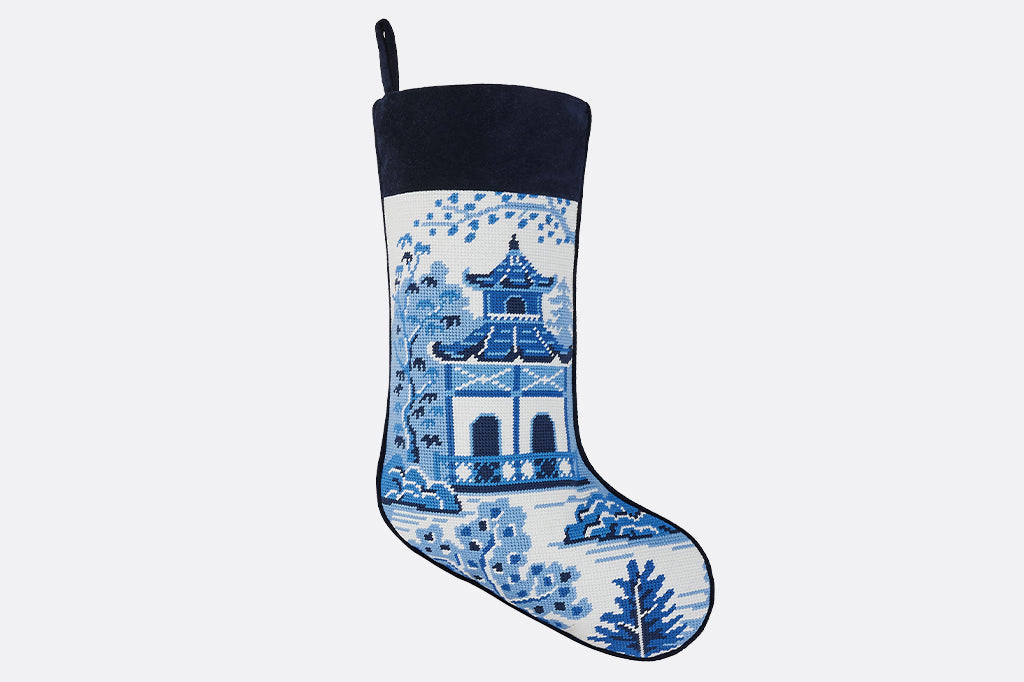 needlepoint blue and white stocking displaying pagoda surrounded by nature and trees