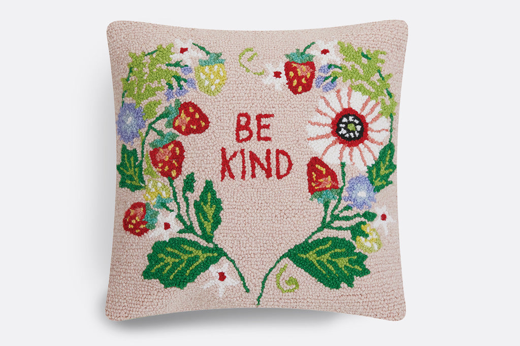 hooked throw pillow. Features strawberry and flower blossoms in a heart around the words "BE KIND."