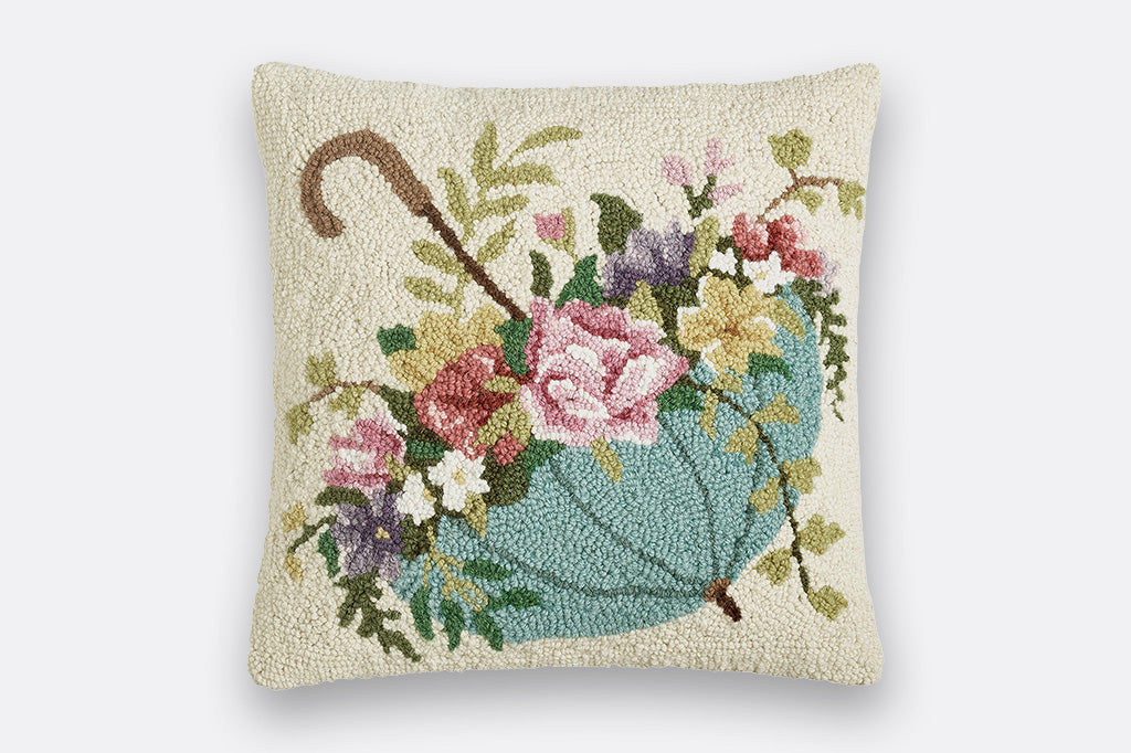 hooked wool pillow; cream background with soft blue umbrella upside-down like a basket full of roses and blooms