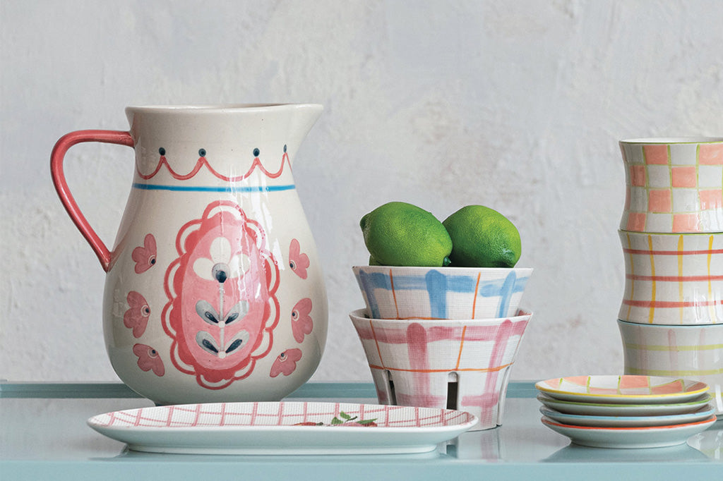 ceramic pitcher, adorned with a French folk art floral design in pretty pinks and blues on a cream background