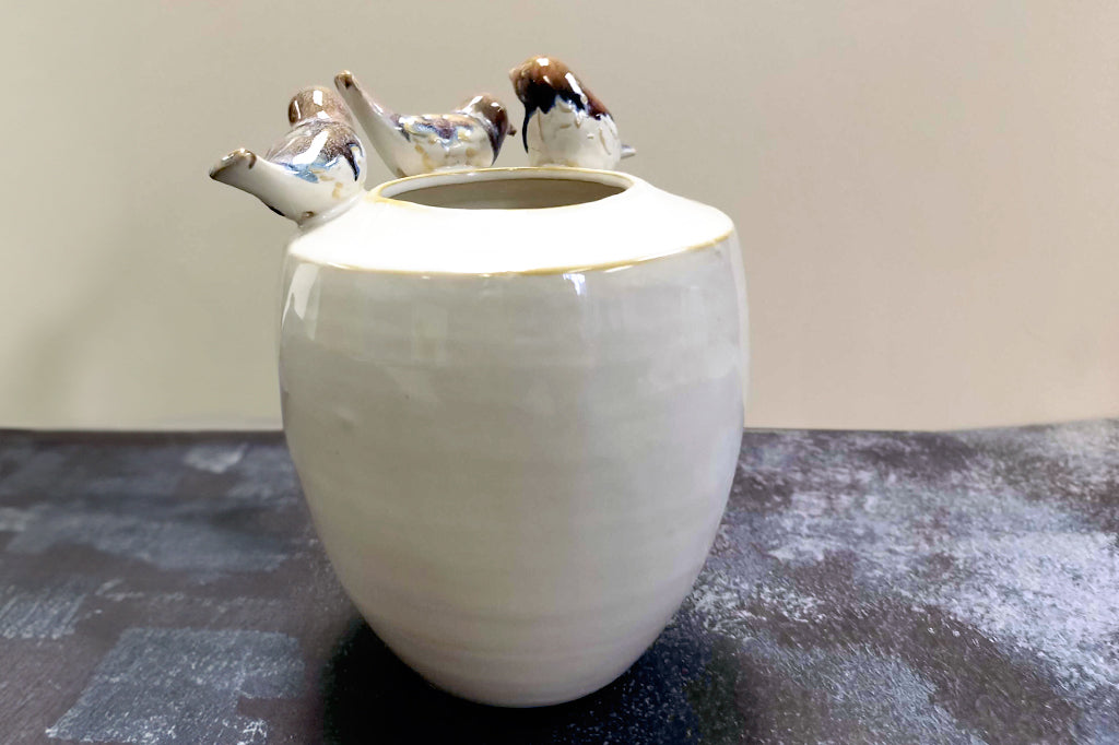 Back view of stoneware vase with 3 birds