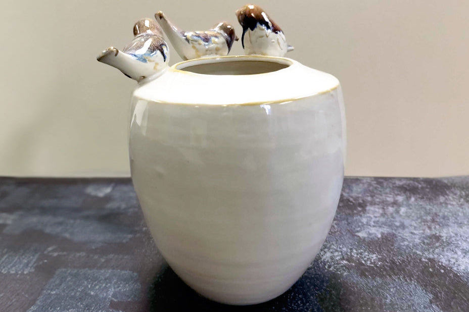 Back view of stoneware vase with 3 birds