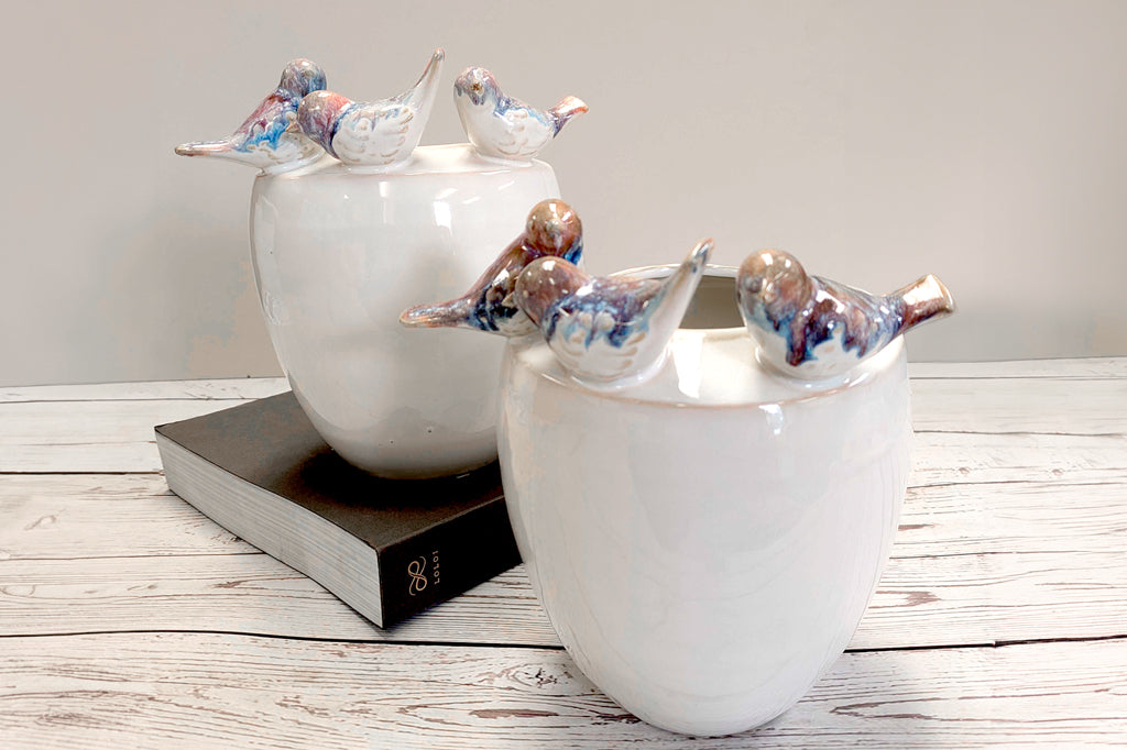 Two vases on a desk. Each has three charming sculpted birds with reactive blue/purple/brown glaze.