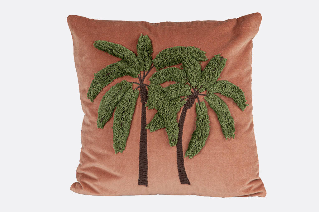 Luxurious velvet square pillow, with two palm trees, dark green leaves with brown trunks, the leaves are a fluffy tufted material 