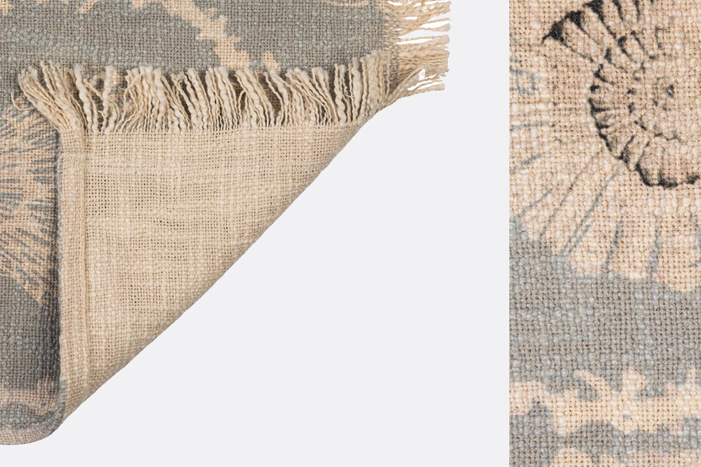 detailed view of woven fabric of blue blanket and fringe 