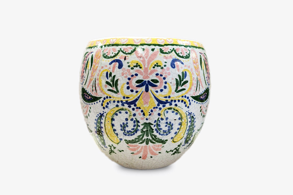 Decorative ceramic pot with colorful floral patterns on a white background
