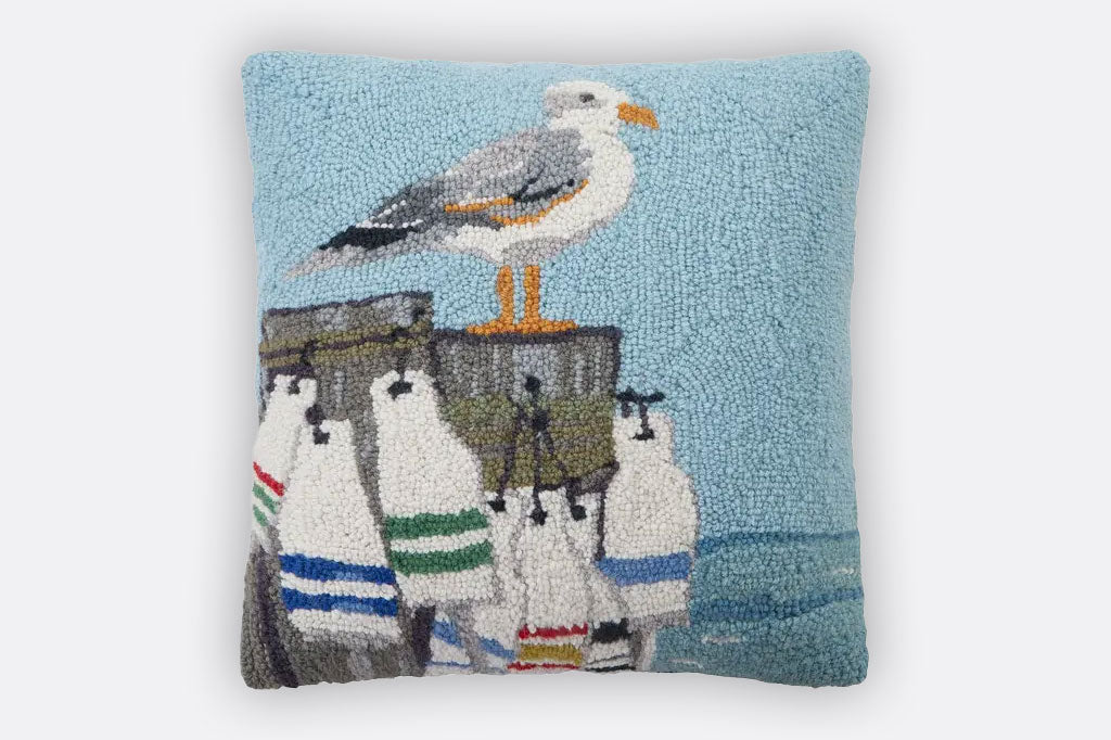 hooked wool throw pillow Featuring a seagull perched upon a buoy filled pier