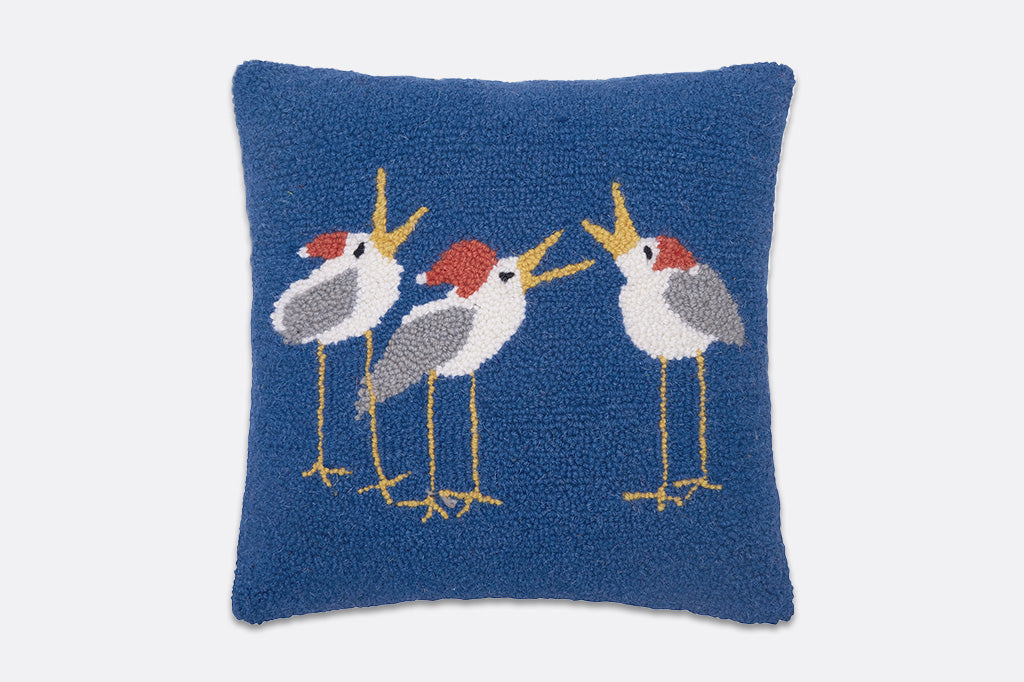 Decorative pillow with embroidered birds on a blue background