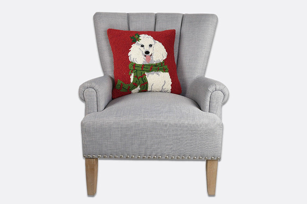 Gray armchair with a red pillow featuring a dog design on a white background
