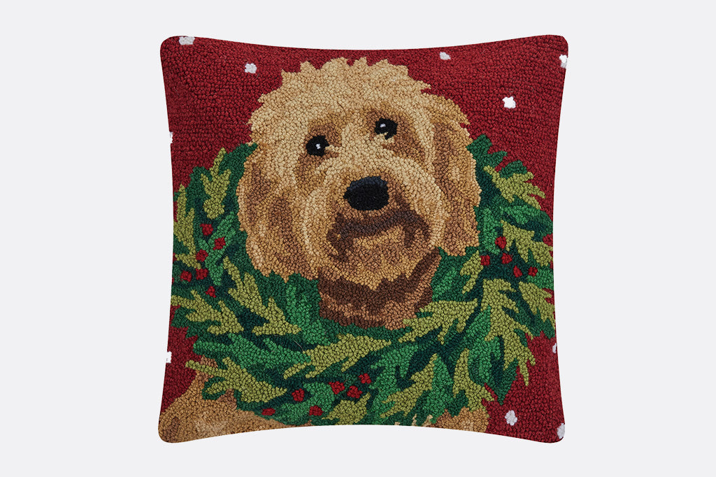 Hooked wool throw pillow with design on brown labradoodle wearing a holiday wreath on its neck
